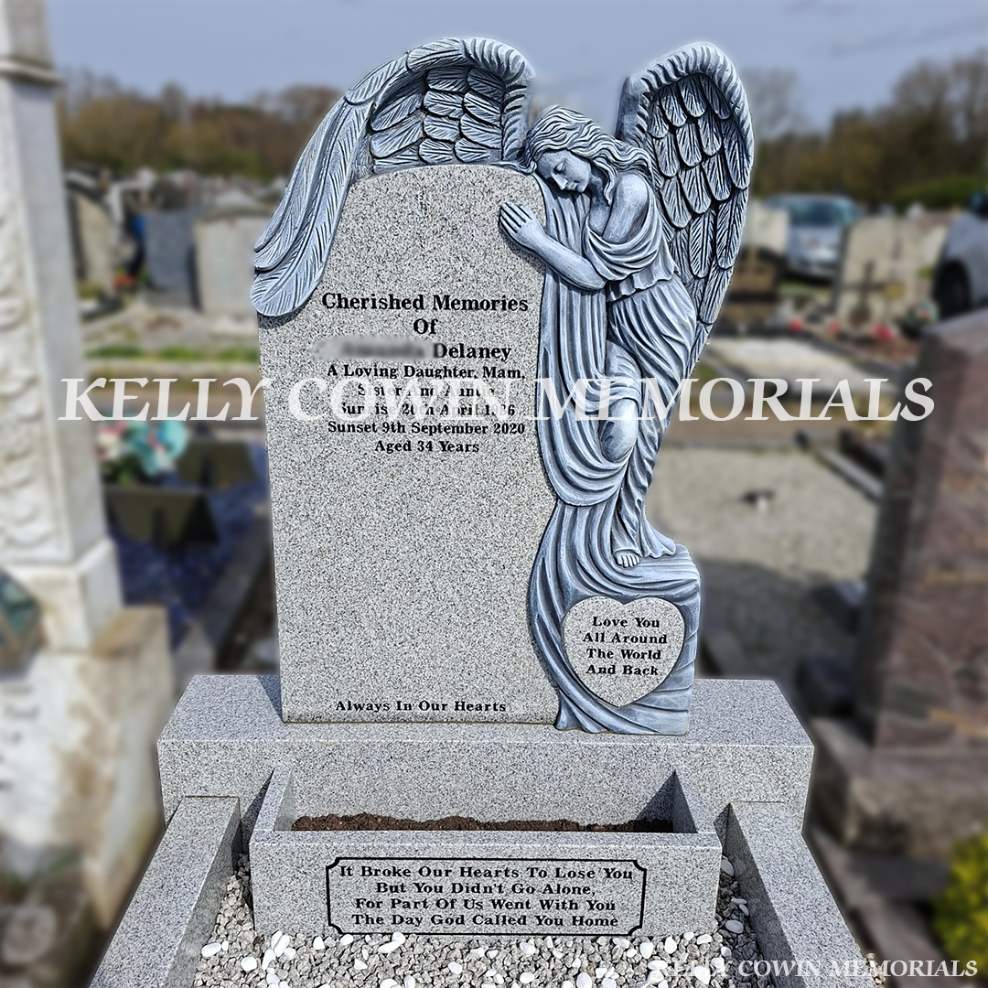 Close up view of grey granite angel headstone with black inscription in Fingal Cemetery