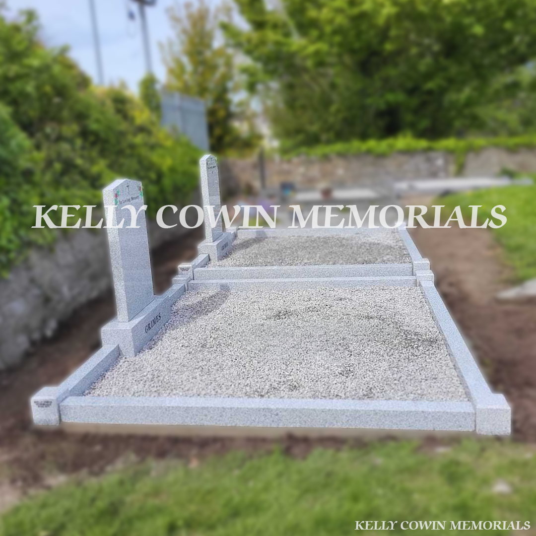 Side view of double grey granite memorials with kerbing and chippings
