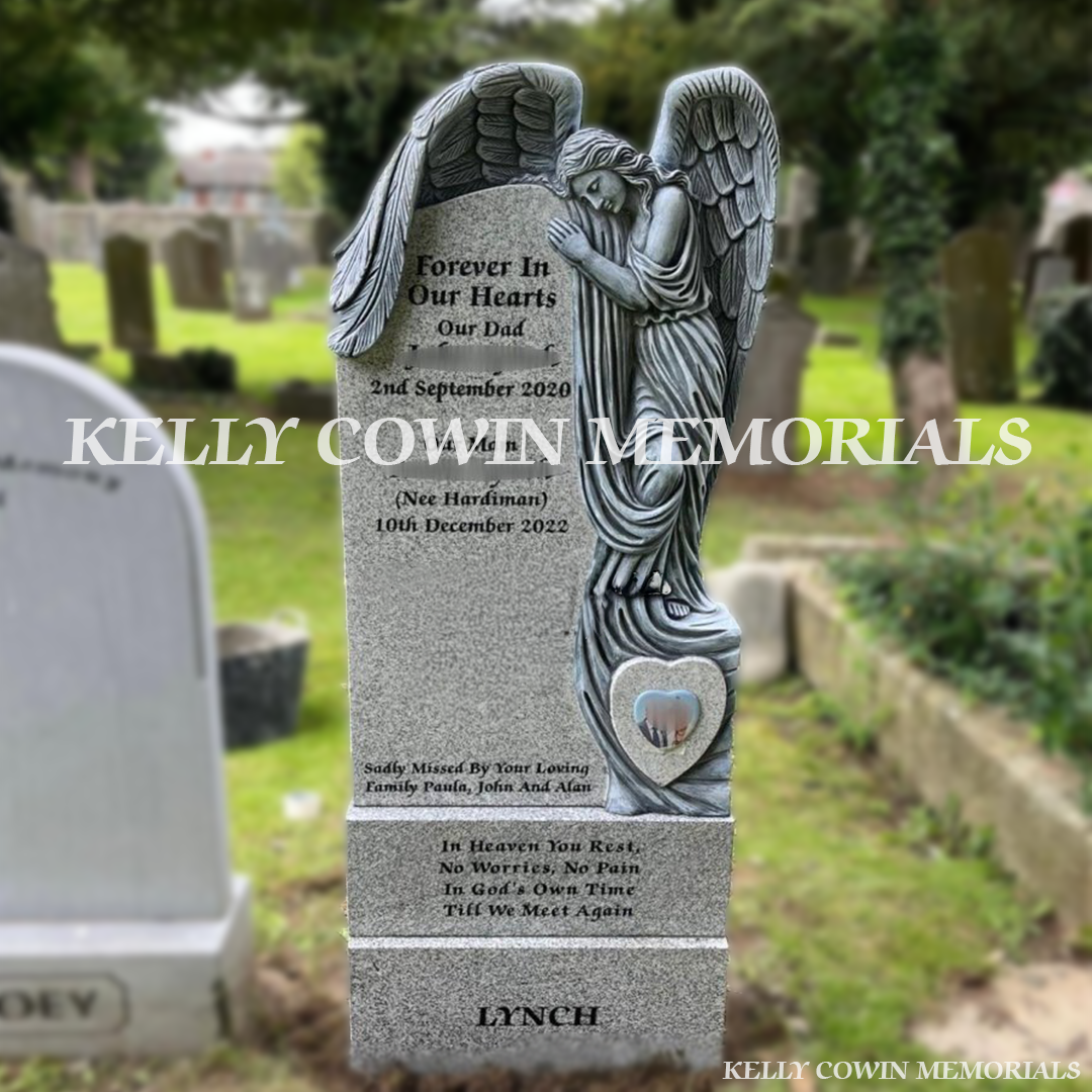 Front view of grey granite carved angel headstone with black inscription in Goldenbridge Cemetery