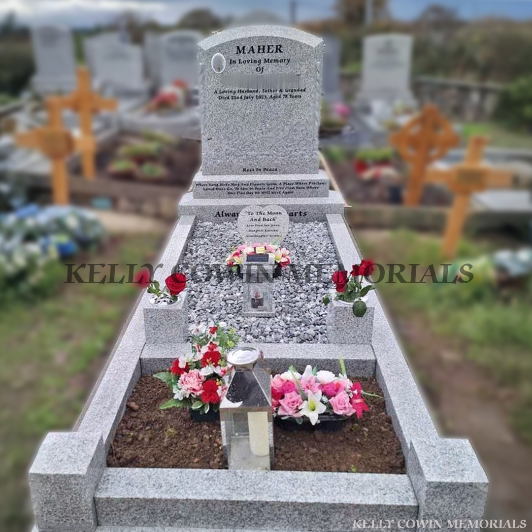 Grey granite boulder memorial headstone with tassel detailing, kerbing, chippings and garden area by Kelly Cowin Memorials Ireland