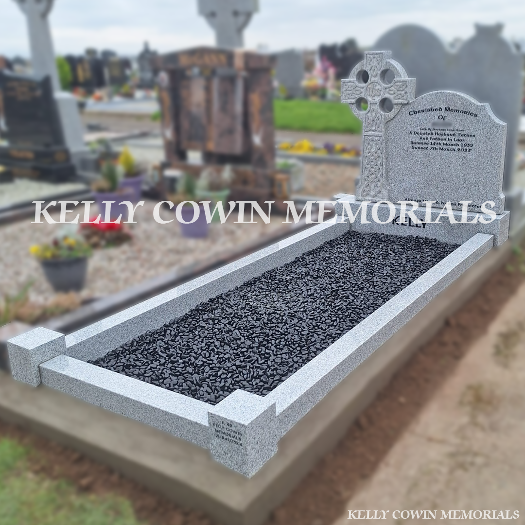 Side view of grey granite memorial with kerbing and black chippings