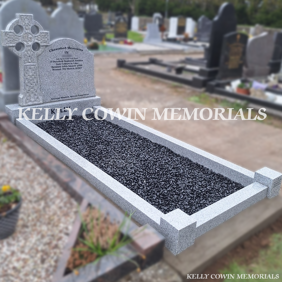 Side view of grey granite memorial with kerbing and black chippings