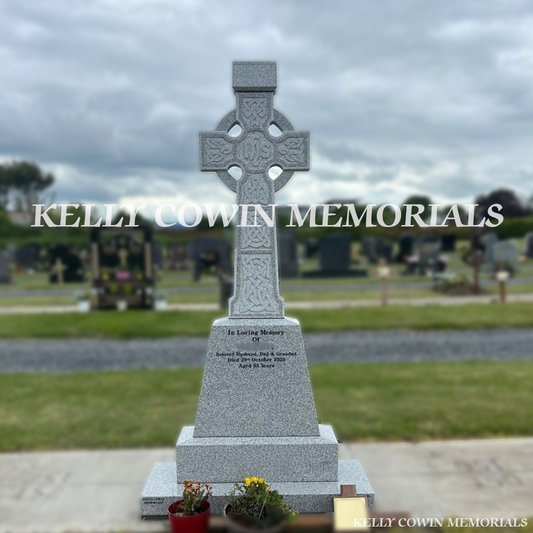 Front view of grey granite Celtic Cross headstone with black inscription on sub-base and plinth in Dardistown Cemetery Dublin