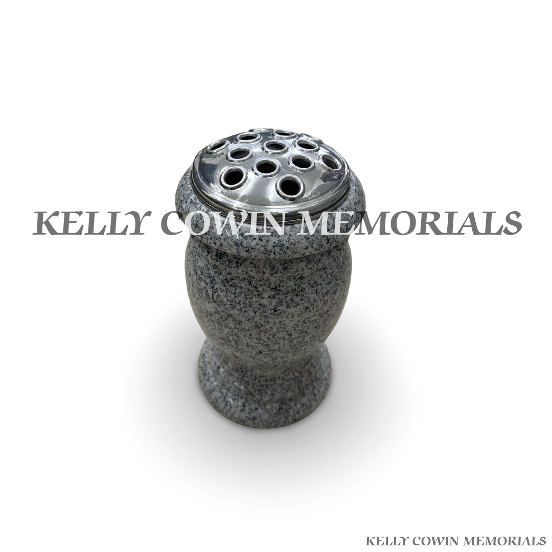 Close-up of speckled grey granite texture and silver lid detail