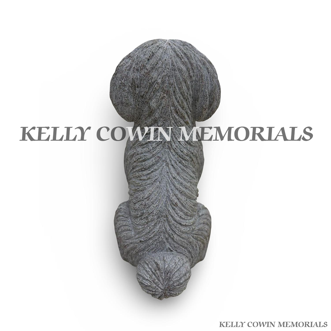 Close-up of polished black granite detailing on grey granite dog memorial