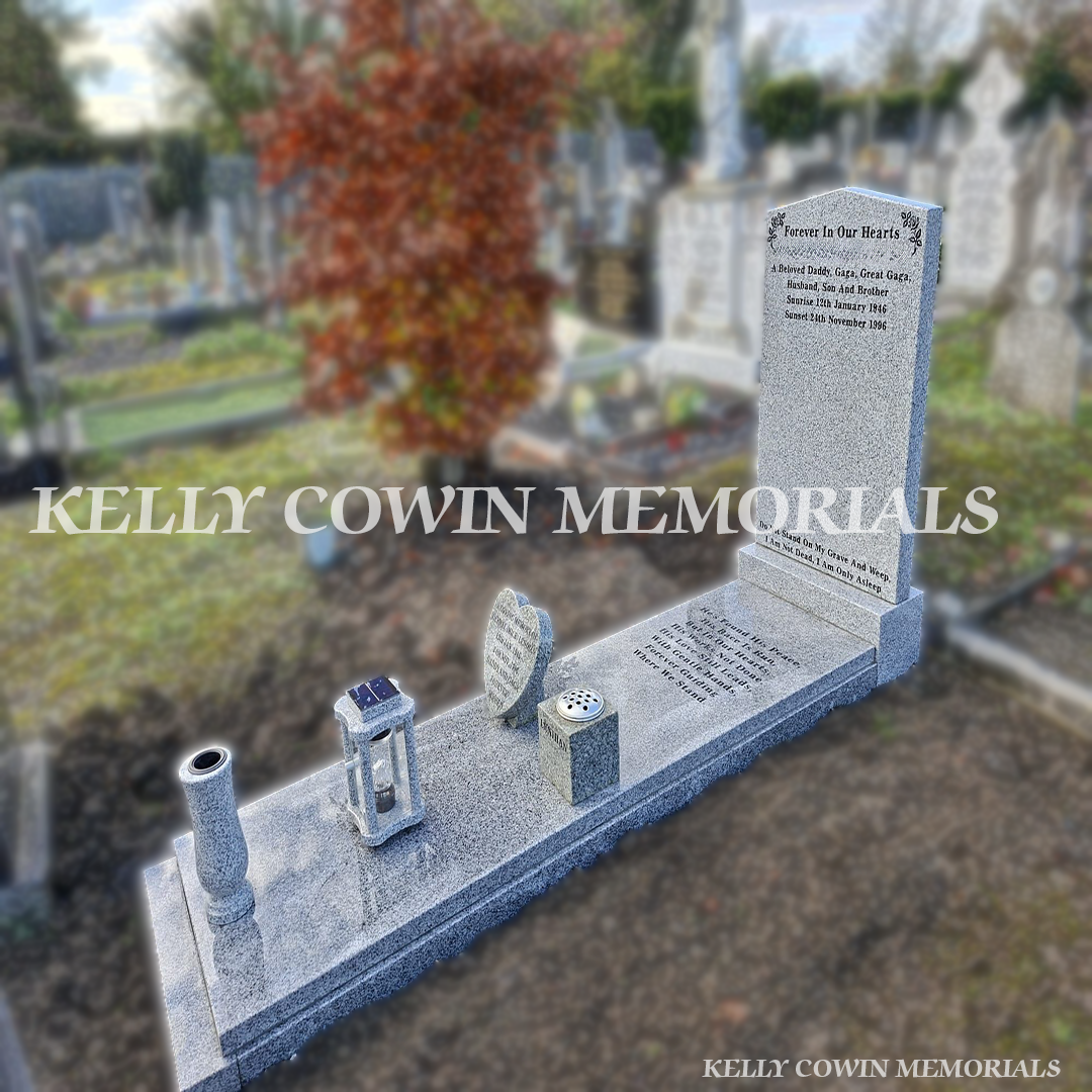 Grey granite headstone with matching kerbing and full-length slab at a completed grave in Glasnevin Cemetery.