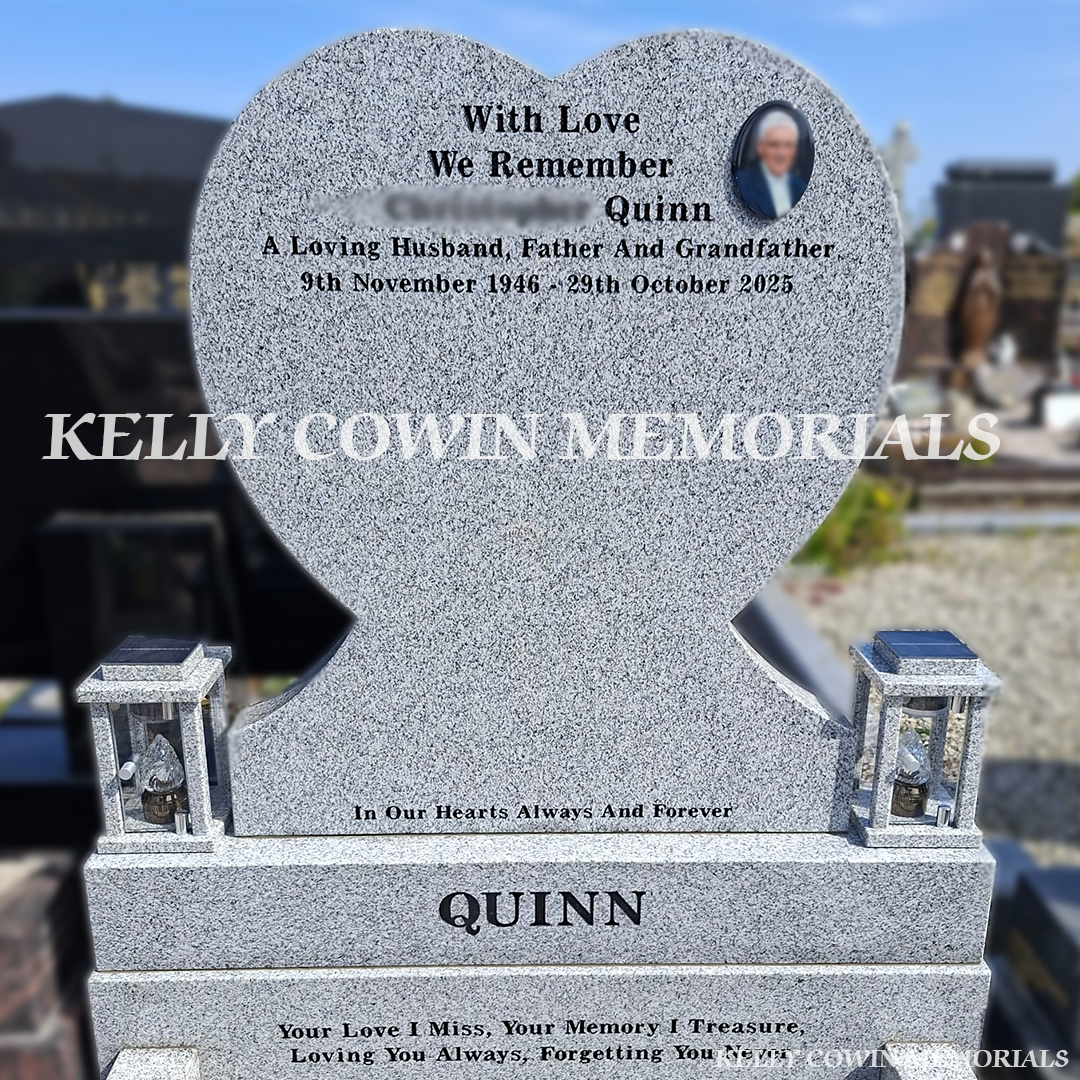 Close-up of black engraved inscription on heart-shaped headstone