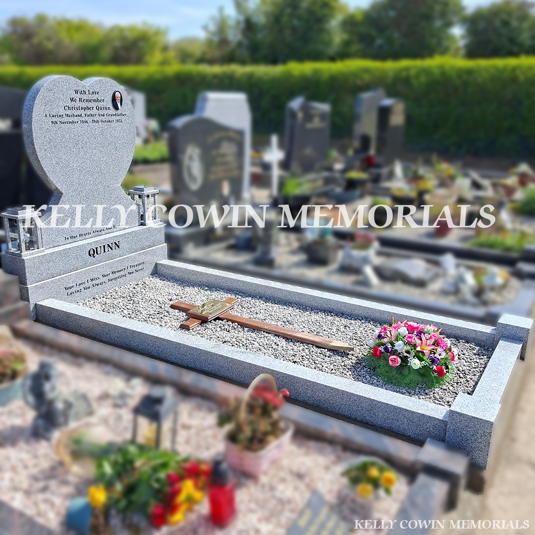 Side view of grey granite memorial with kerbing and solar lanterns