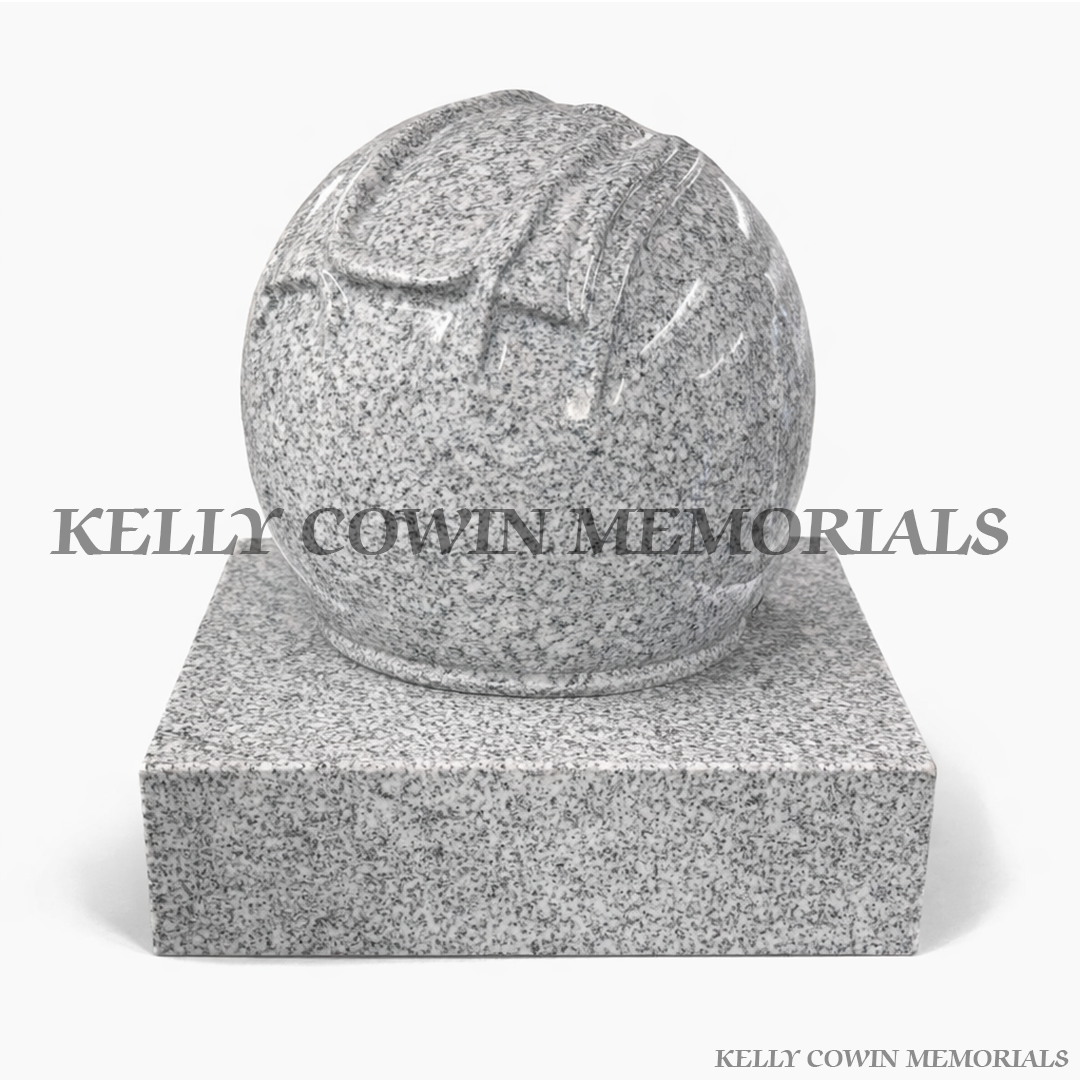 Grey granite motorcycle helmet grave accessory with polished finish on granite base by Kelly Cowin Memorials Ireland