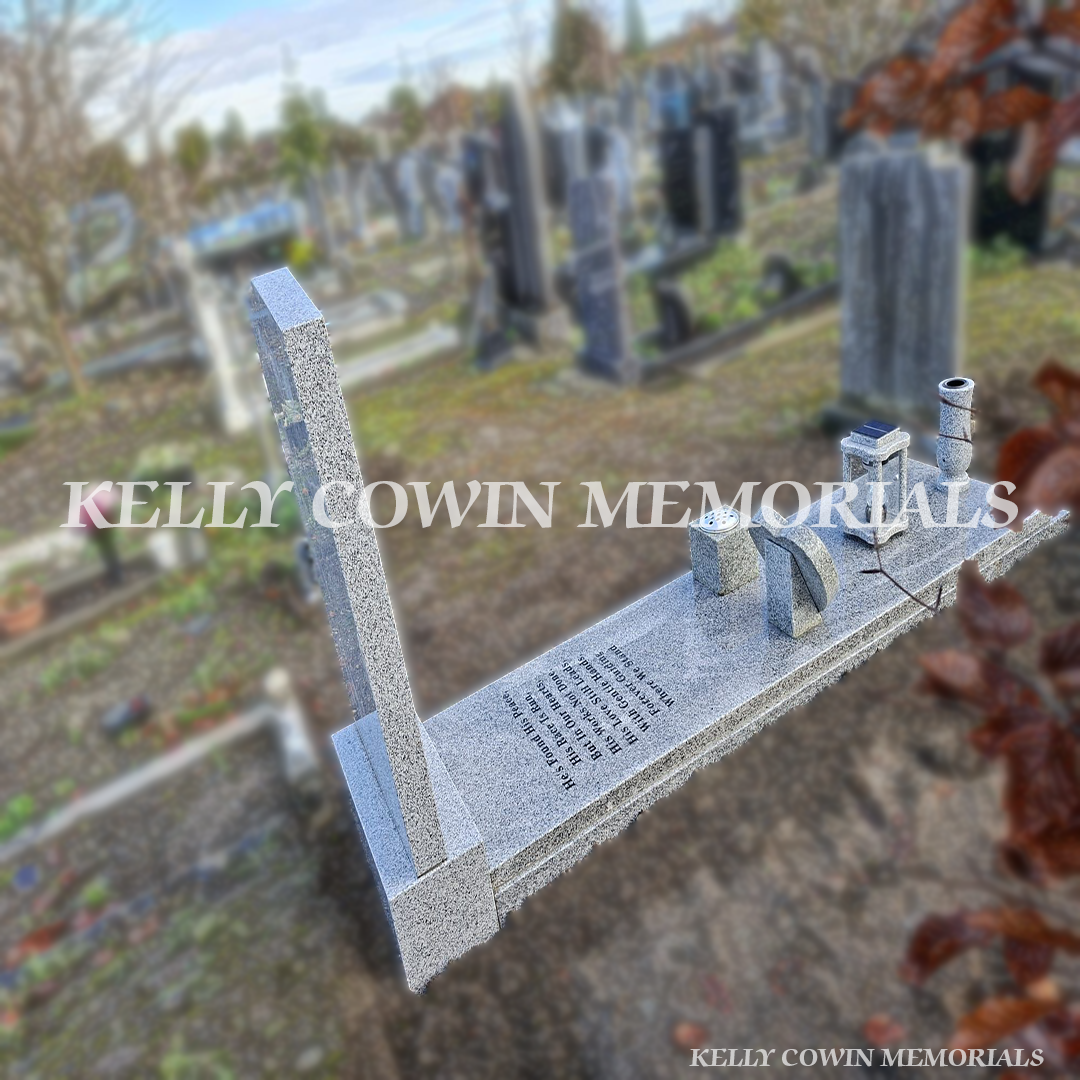 Angled view of grey granite apex headstone showing polished finish, black inscription and full granite slab.