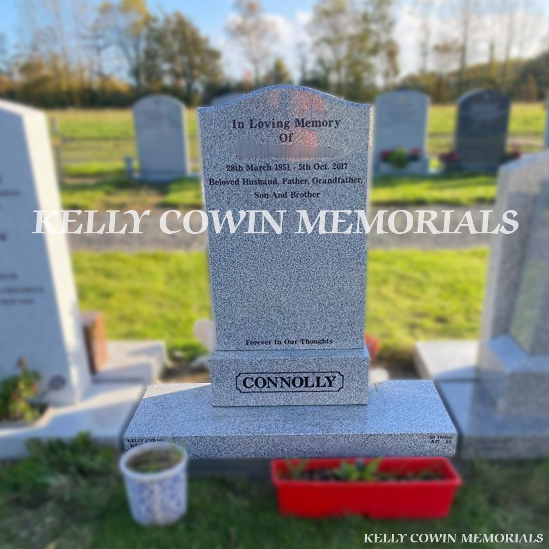 Front view of grey granite OG headstone with black inscription in Shanganagh Cemetery