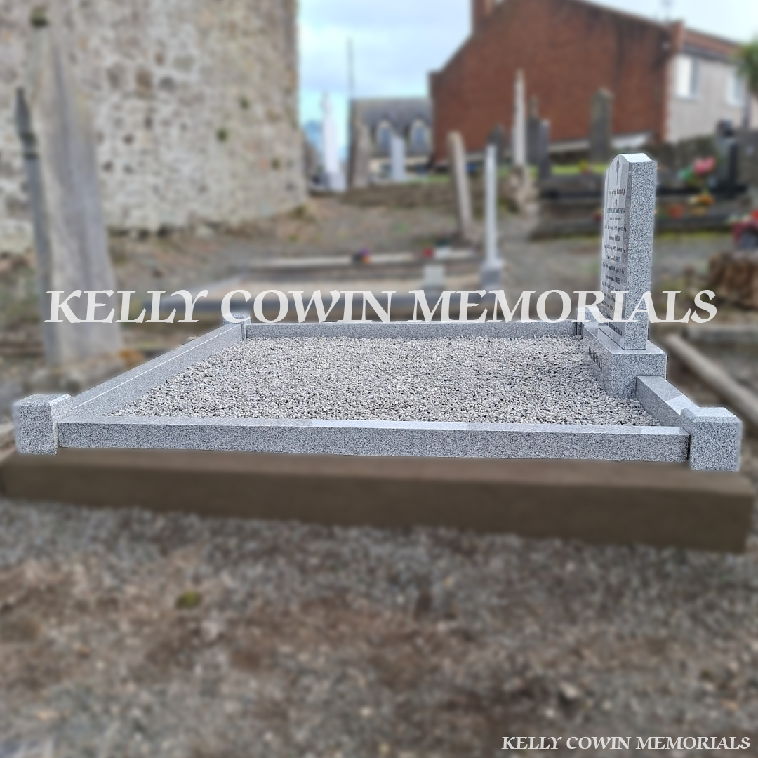 Side view of grey granite memorial with kerbing and corner posts