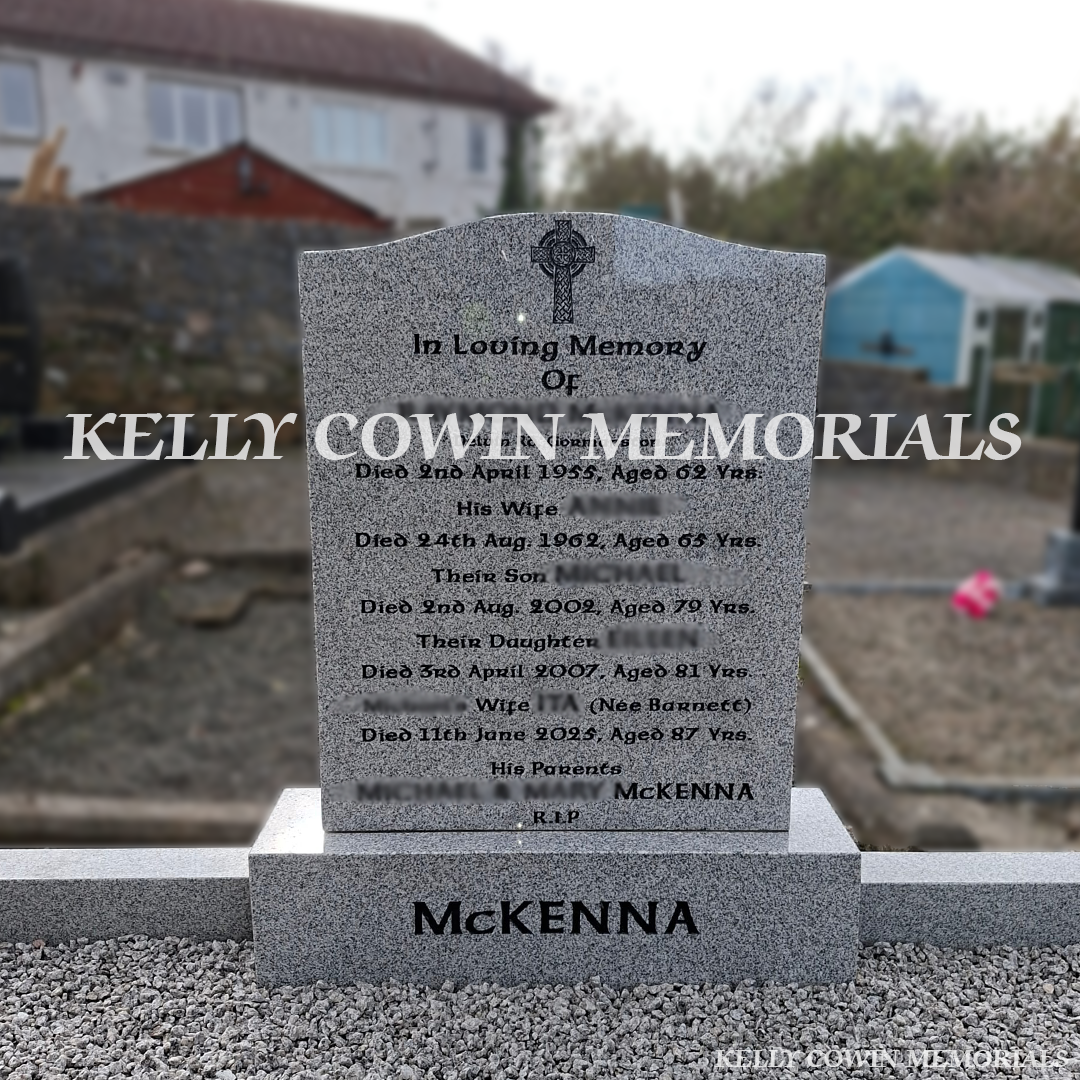 Front close up view of grey granite OG headstone with black inscription on double plot