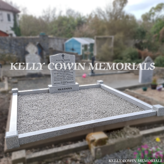 Front view of grey granite OG headstone with black inscription on double plot