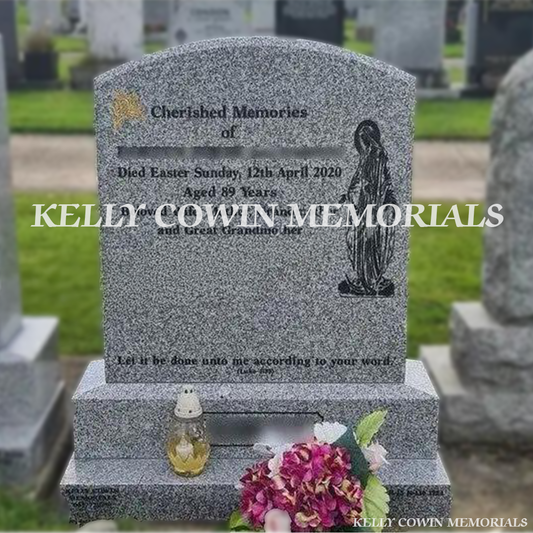 Front view of grey granite polished boulder headstone with black inscription in a Dublin Cemetery