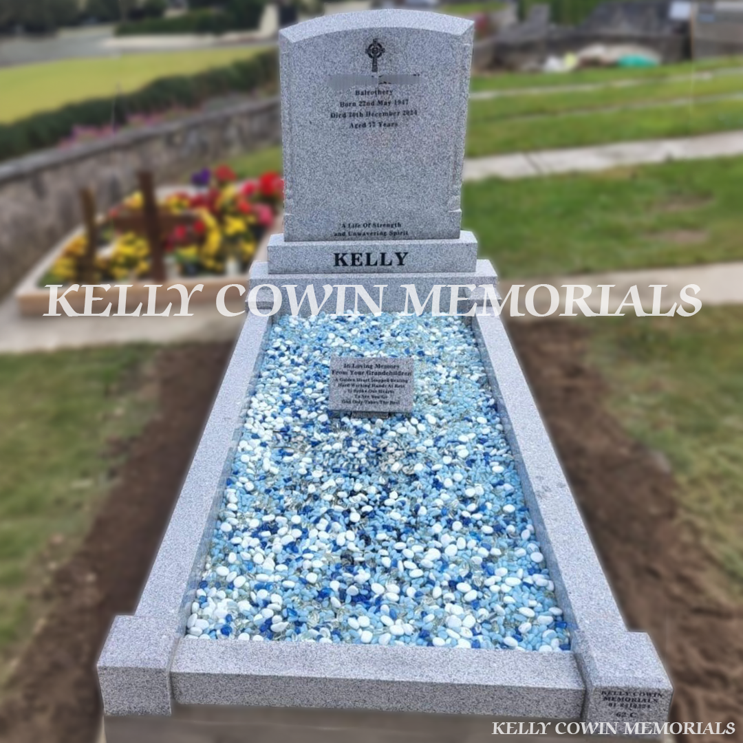 Front view of grey granite polished boulder headstone with black inscription in Balrothery Cemetery