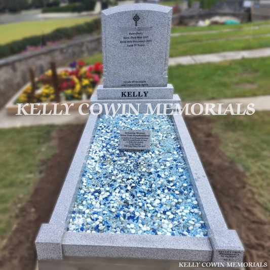 Front view of grey granite polished boulder headstone with black inscription in Balrothery Cemetery