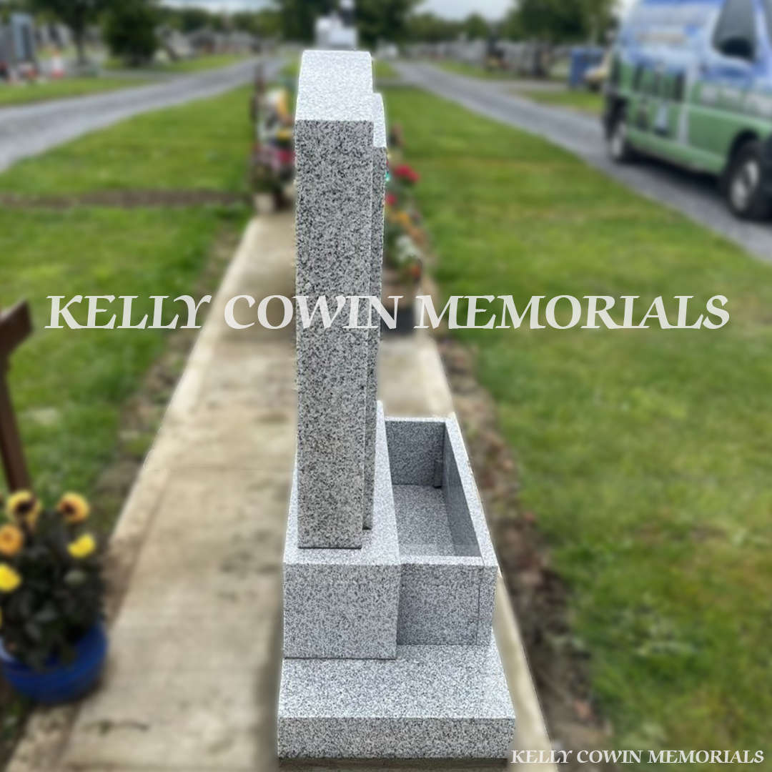 Side view of grey granite boulder headstone showing base, plinth and polished face in Dardistown Cemetery