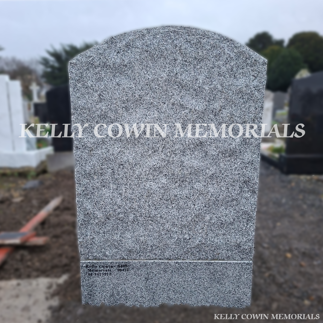 Rear view of grey granite rough edge boulder headstone in Mount Jerome Cemetery Dublin