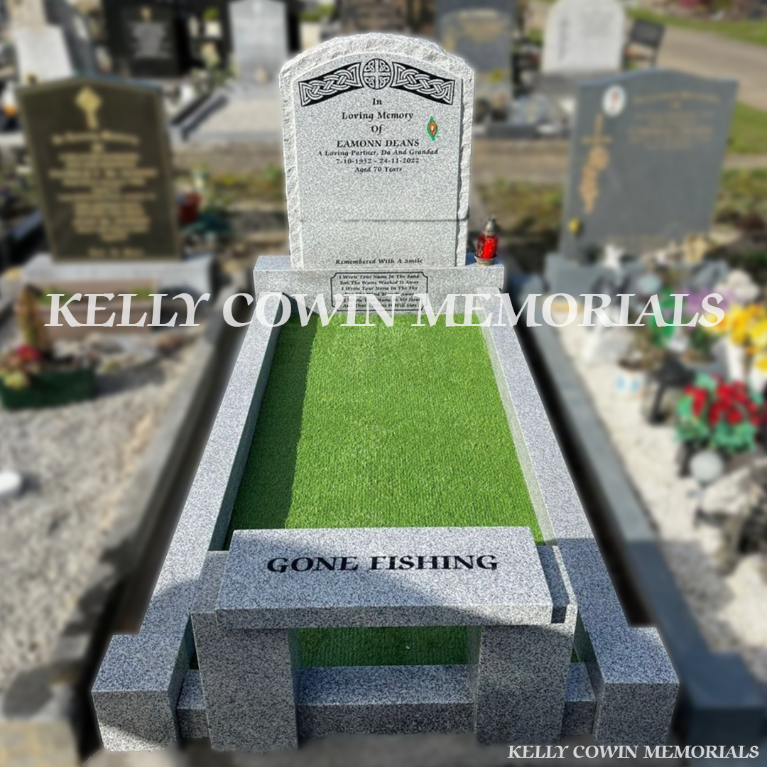 Front view of grey granite rough edge boulder headstone with black inscription in Fingal Cemetery Dublin