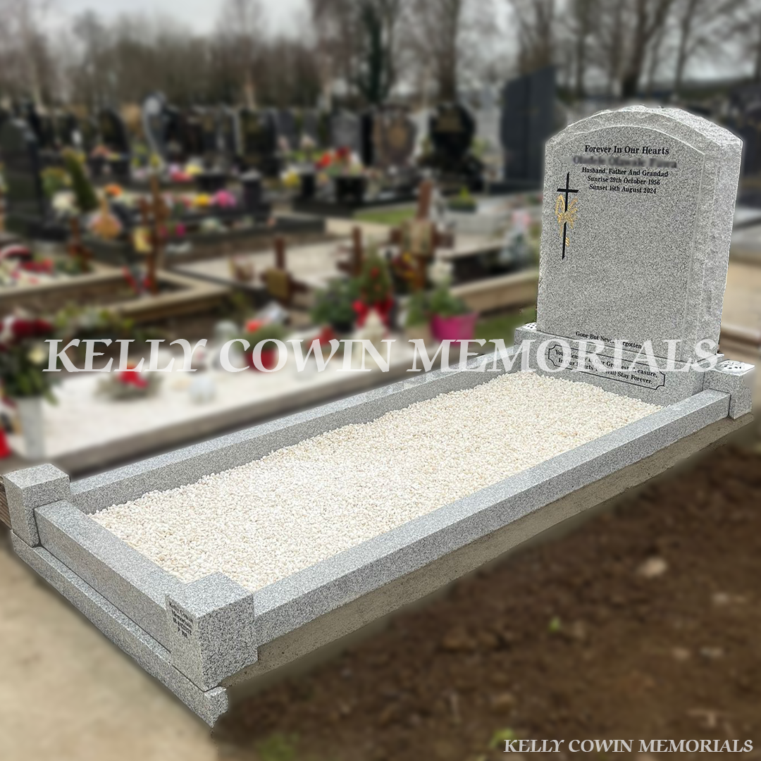 Grey granite rough boulder headstone with kerbing installed in Mulhuddart Cemetery by Kelly Cowin Memorials