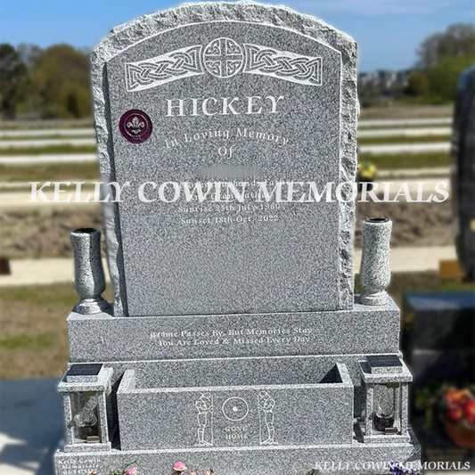 Front view of Grey Granite rough boulder headstone with flower box, vases and solar lanterns erected in Balgriffin Cemetery Dublin