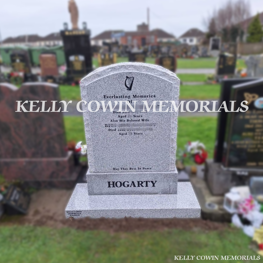 Front view of grey granite rough edge boulder headstone with black inscription in Newlands Cross Cemetery