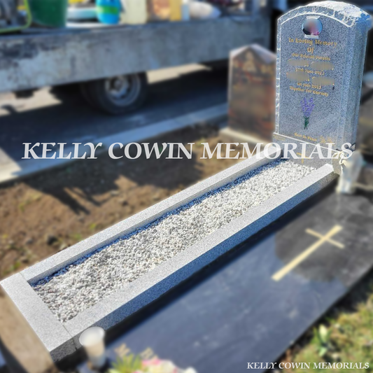 Side view of Grey Granite boulder memorial showing rough edges, kerbing and ceramic photograph in Glasnevin Cemetery