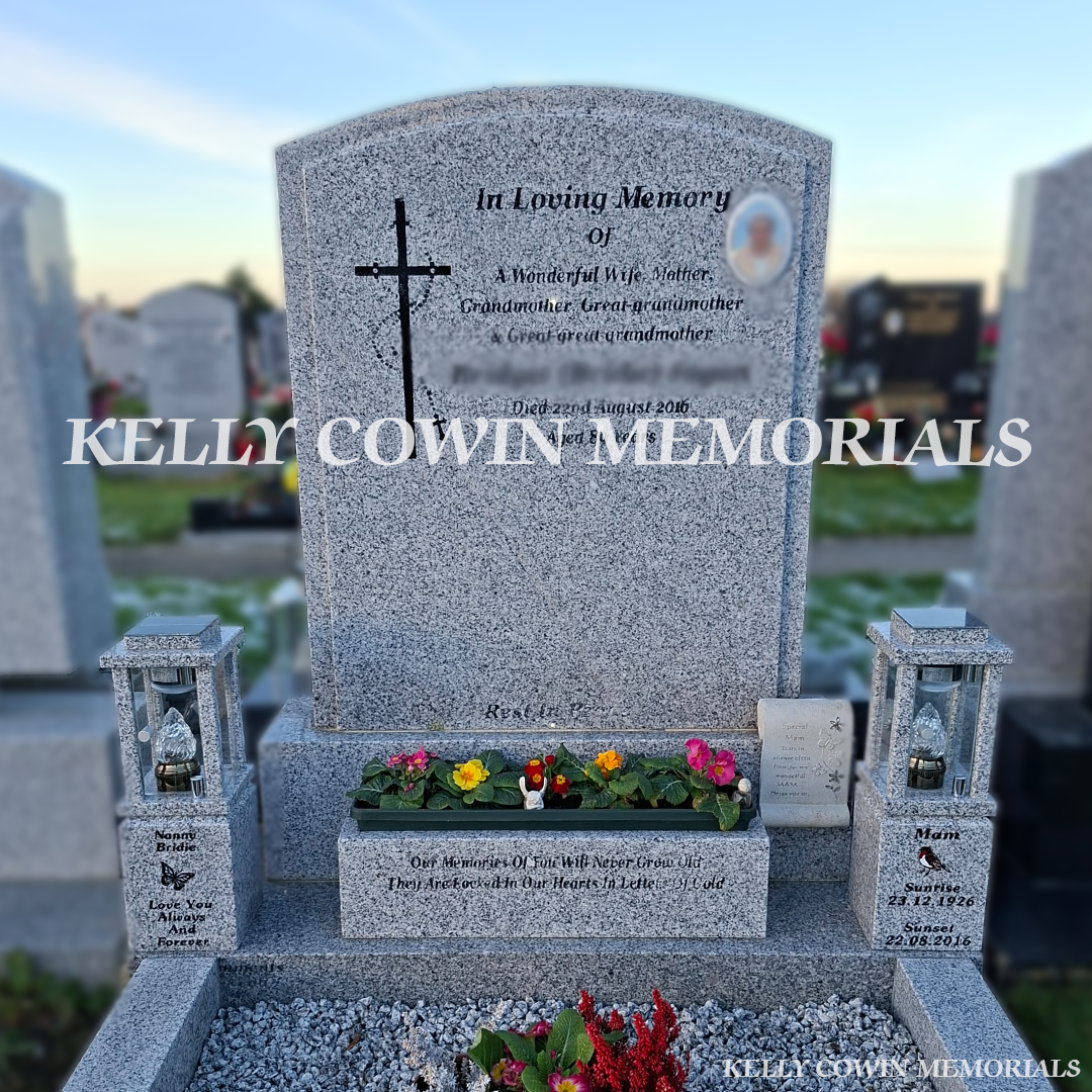 Front view of grey granite solar lanterns with black engraving and robin and butterfly images in cemetery