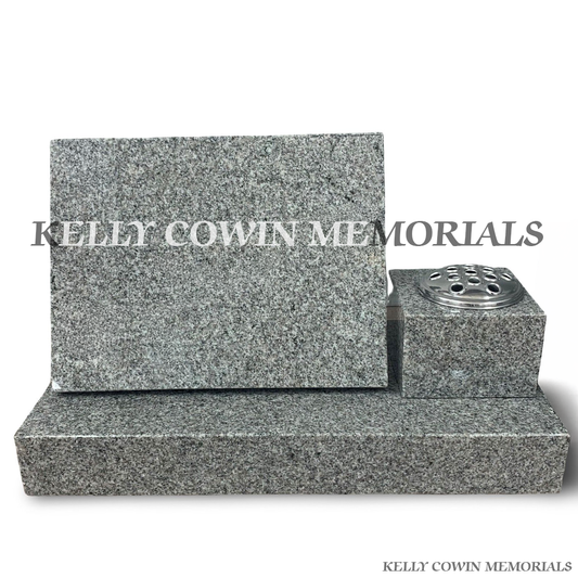 Front view of grey granite square vase and 12x18 memorial plaque on plinth