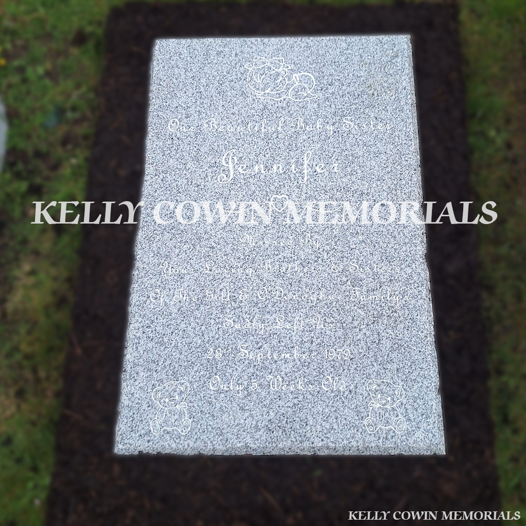 Front view of grey granite St. Fintan’s headstone with white inscription in Sutton