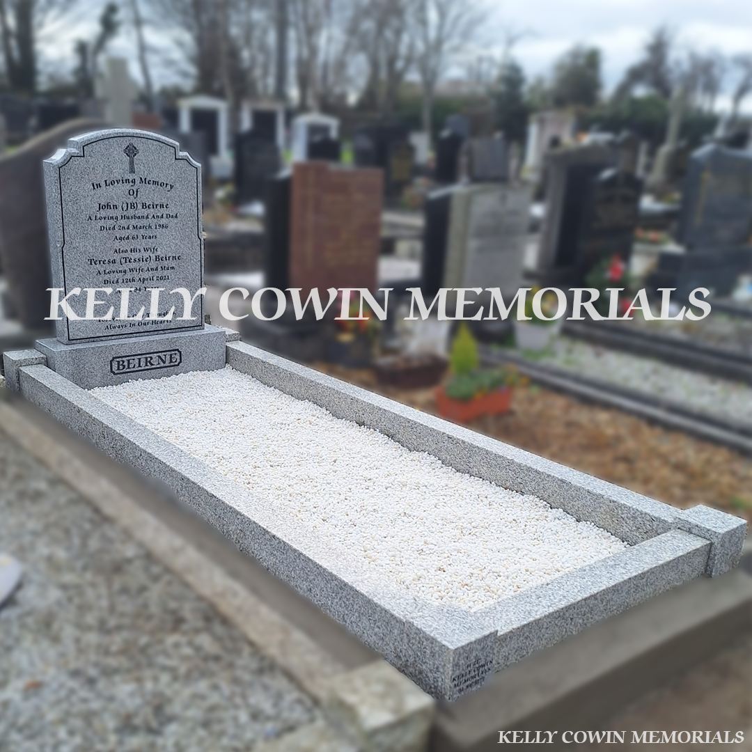 Side view of grey granite memorial with kerbing and white Moldovan chippings