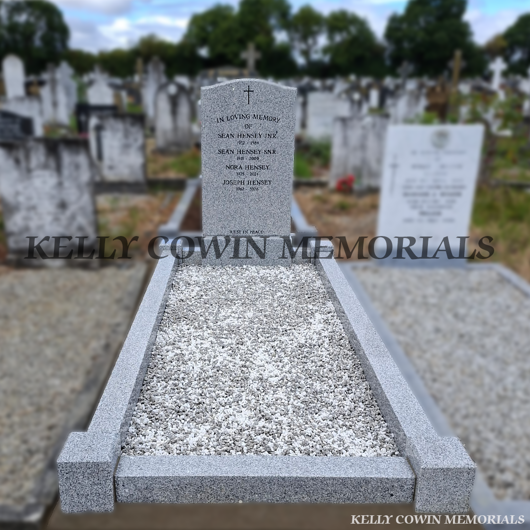 Grey OG granite headstone with black inscription, granite base, kerbing and corner posts installed in Balgriffin Cemetery Dublin by Kelly Cowin Memorials.