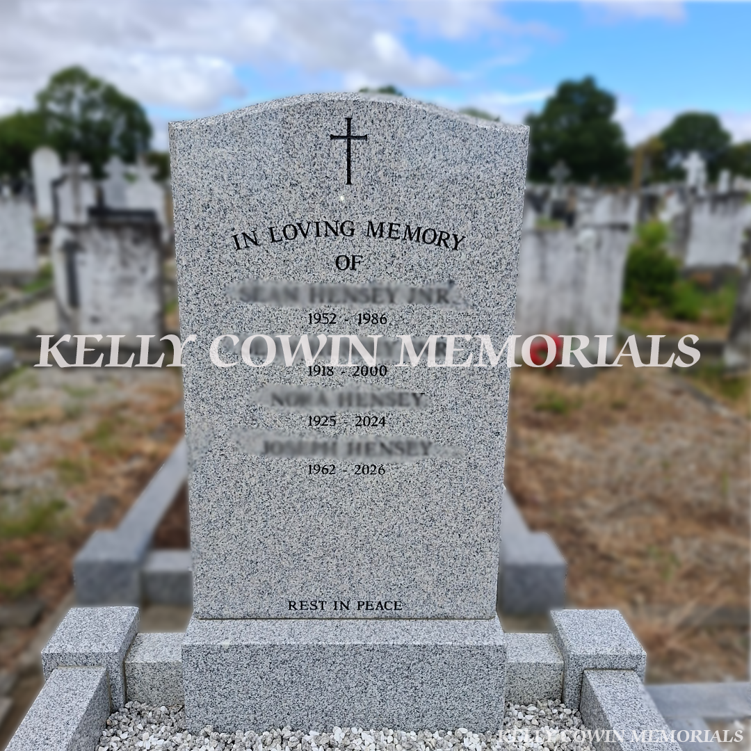 Grey OG granite headstone and full grave surround with grey granite kerbing, four corner posts and white Moldovan chippings in Balgriffin Cemetery Dublin.