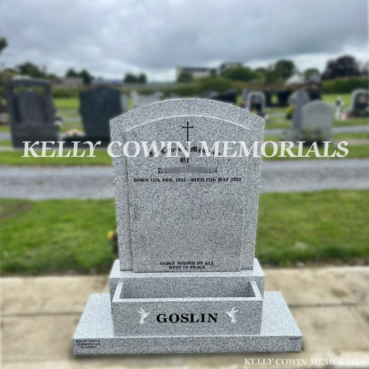 Front view of grey granite polished boulder headstone with black inscription and flower box in Dardistown Cemetery Dublin