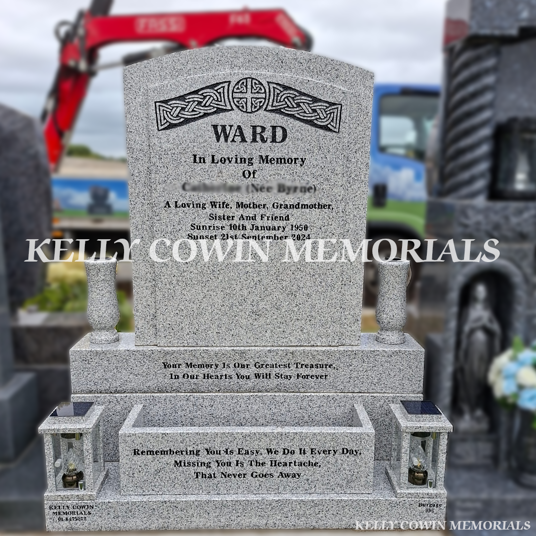 Grey polished boulder granite headstone with Celtic carving, flower box, two granite vases, two solar lanterns and black inscription installed in Balgriffin Cemetery Dublin by Kelly Cowin Memorials.