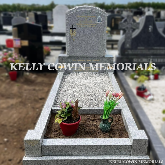 Front view of grey granite rough edge boulder headstone with gold inscription in Ardla Cemetery Dublin