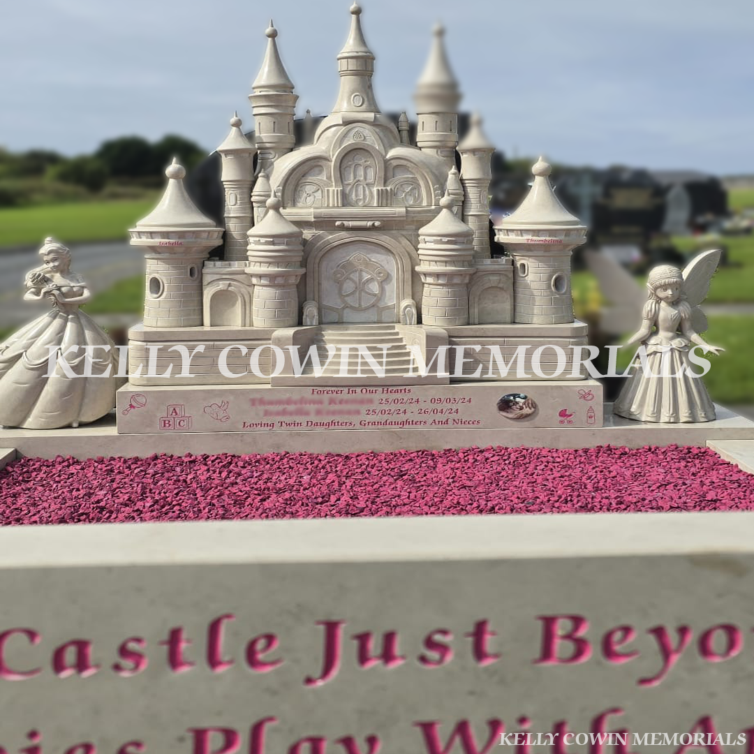 Detailed stone princess castle headstone with carved towers and pink lettering installed in County Clare.
