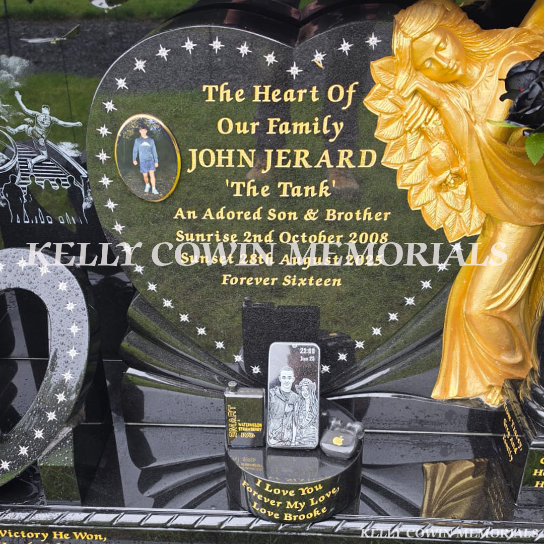 Gold rose-carved angel beside heart-shaped inscription panel on bespoke black granite headstone in Dublin.