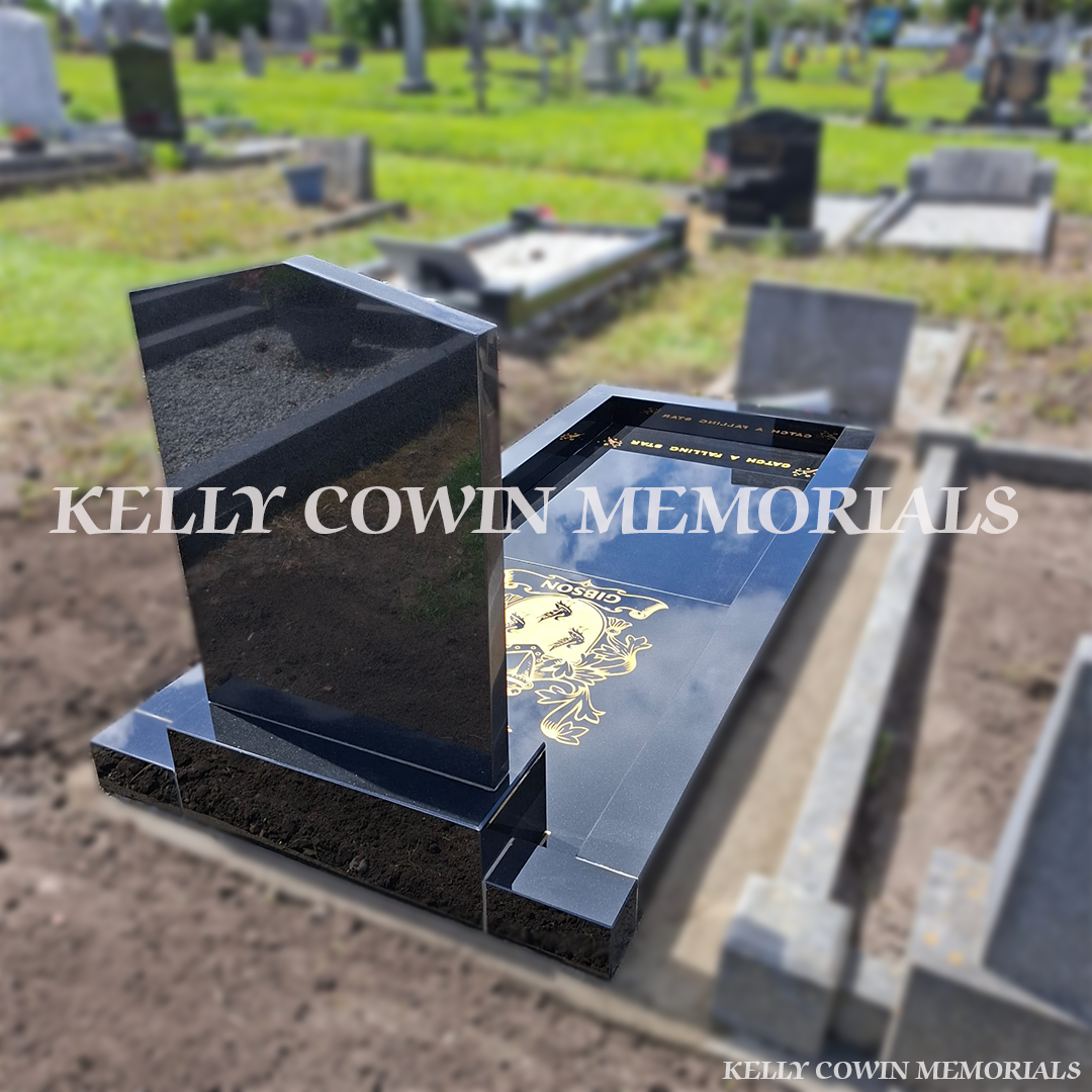 Rear view of a premium Black Granite Apex memorial with full granite floor, polished kerbing and bespoke engraved details, expertly erected in Kilbarrack Cemetery by Kelly Cowin Memorials.
