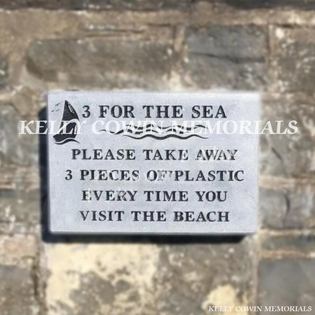 Front view close up of limestone memorial plaque with black engraved wording