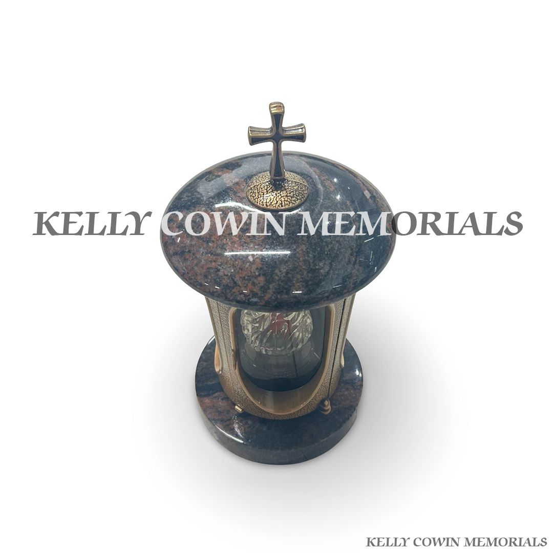Close-up of bronze cross and hardware on Pandora granite lantern