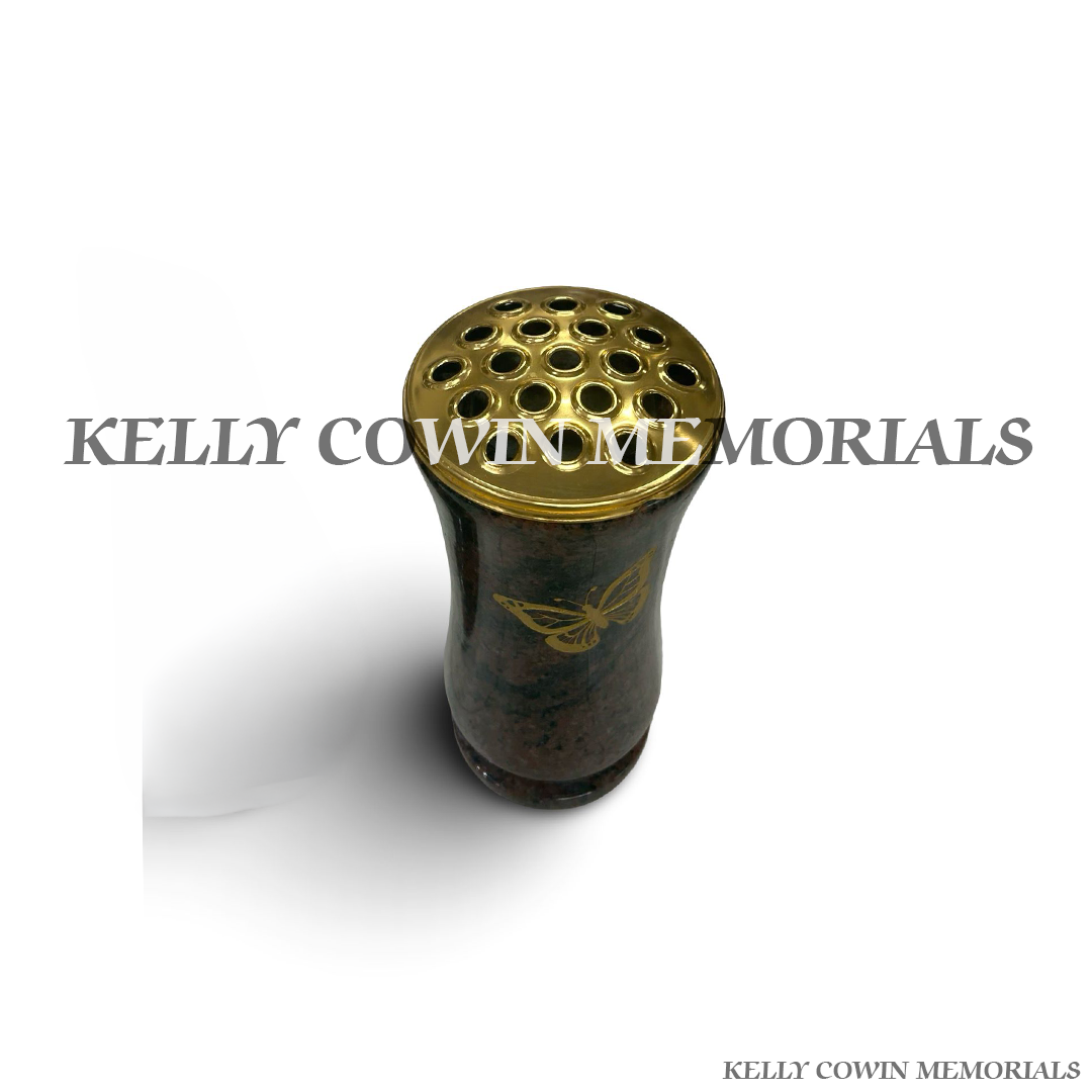 Close-up of gold butterfly engraving on Pandora granite vase