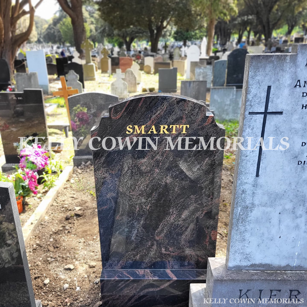 Back view of full-length granite headstone and grave surround at Glasnevin Cemetery.