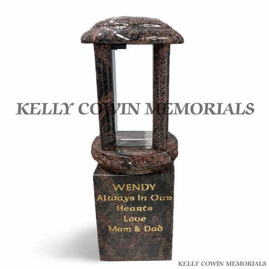 Front view of round Pandora granite lantern on engraved granite block