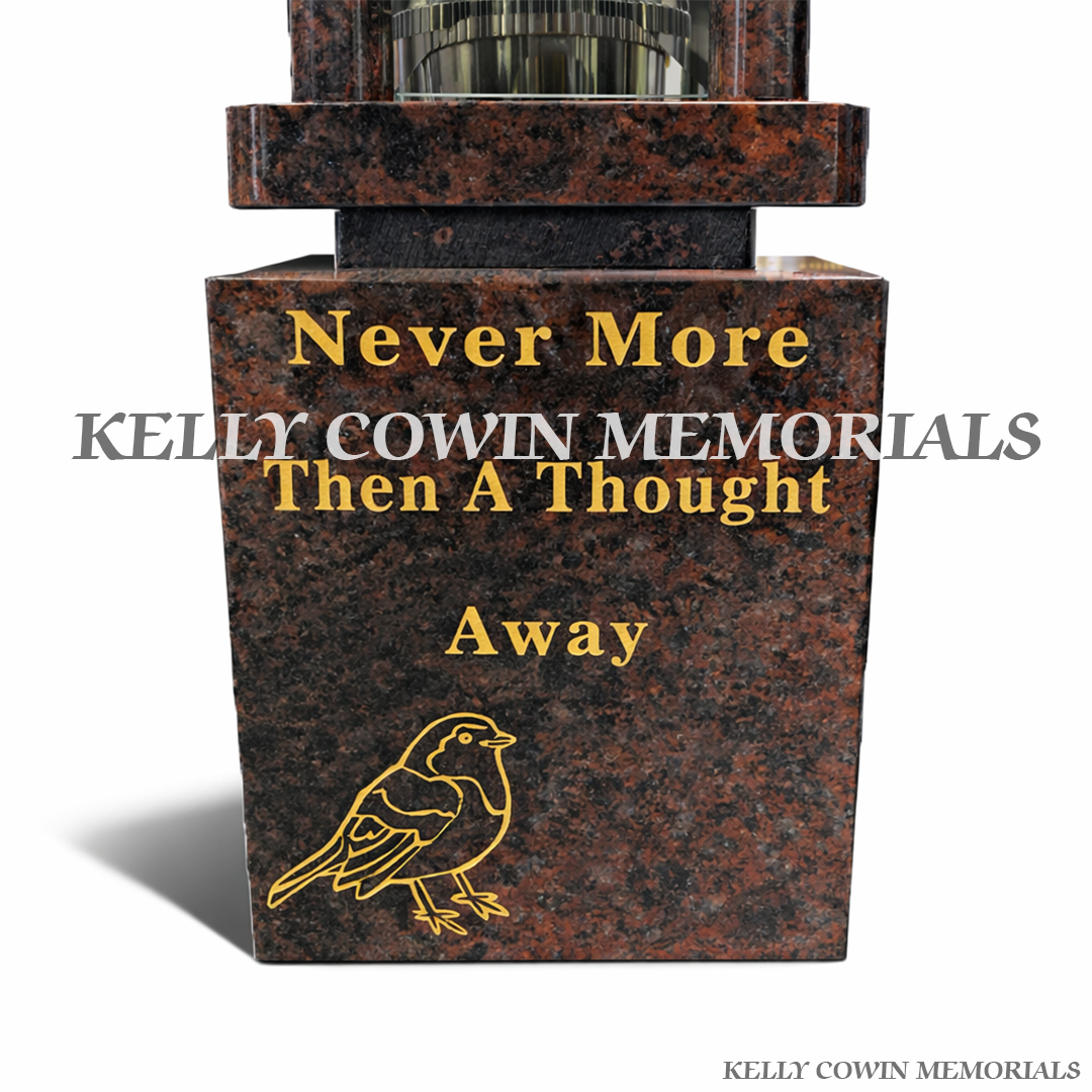 Close-up of gold engraved robin image on Pandora granite memorial block