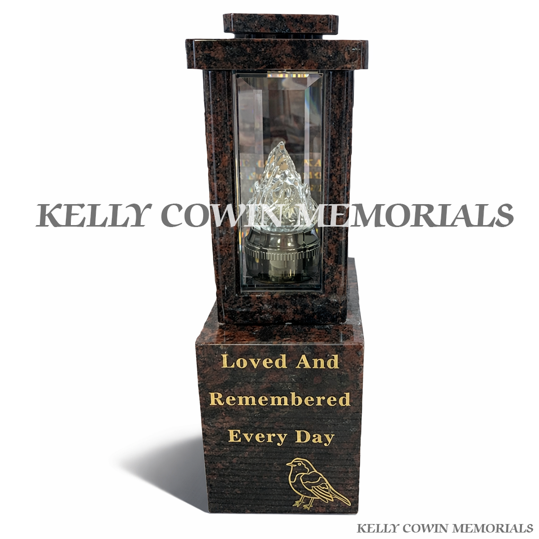 Front view of two Pandora granite lanterns with gold robin engraving