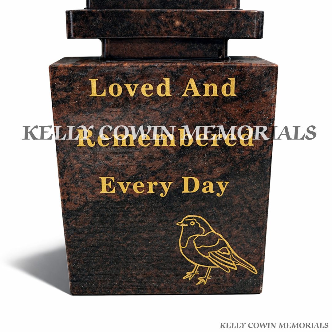 Close-up of gold engraved robin image on Pandora granite memorial block