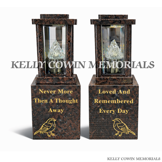Front view of two Pandora granite lanterns with gold robin engraving