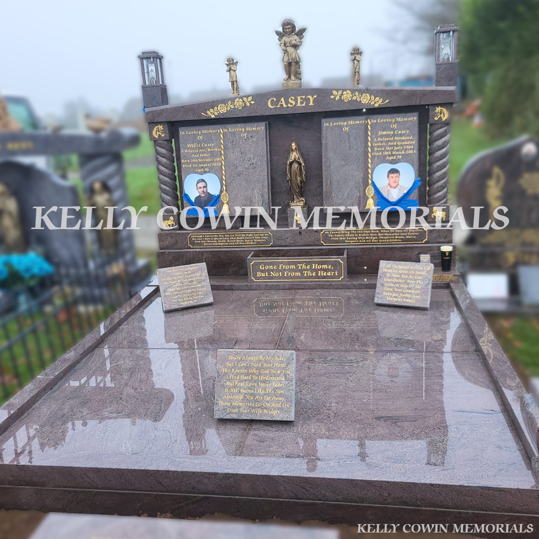 Paradiso granite double book Traveller headstone with statues, gold leaf inscription and heart plaques in Mount St Oliver Cemetery, Limerick